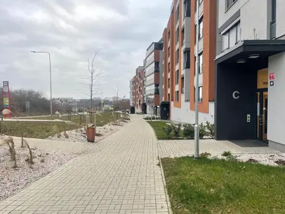 a brick sidewalk in front of a building at Newly built Studio in Prague Near Metro Haje in Prague