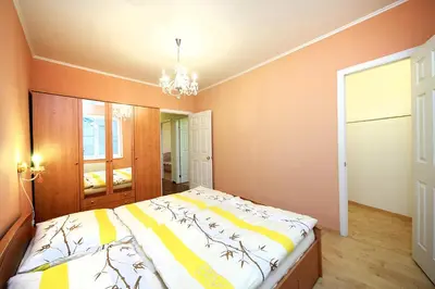 a bedroom with a bed and a chandelier at AP Antonie in Prague