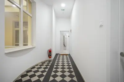 a hallway with a black and white checkered floor at The new brickhouse apartment in Prague