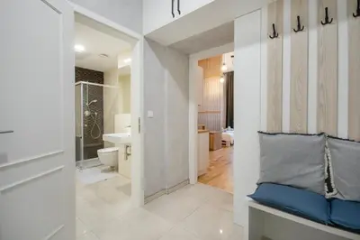 a bathroom with white walls and a bench with a pillow at The new brickhouse apartment in Prague