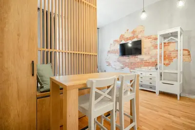 a dining room with a wooden table and chairs at The new brickhouse apartment in Prague
