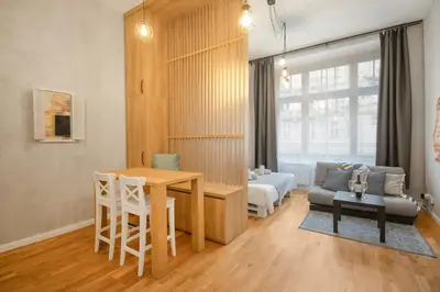a living room with a table and a couch at The new brickhouse apartment in Prague