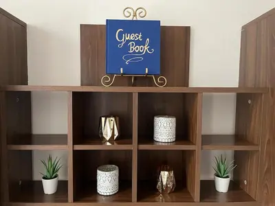 a wooden book shelf with ajust box sign on it at Harrison Homes Apartment 03 - Prague City Centre in Prague