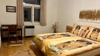 a bedroom with a bed and a desk and a window at Harrison Homes Apartment 03 - Prague City Centre in Prague