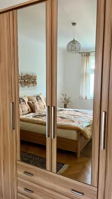 a wooden cabinet with a glass door in a bedroom at Harrison Homes Apartment 03 - Prague City Centre in Prague