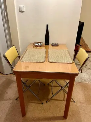 a wooden table with a bottle of wine on it at Harrison Homes Apartment 03 - Prague City Centre in Prague