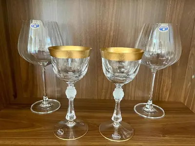a group of four wine glasses sitting on a table at Harrison Homes Apartment 03 - Prague City Centre in Prague