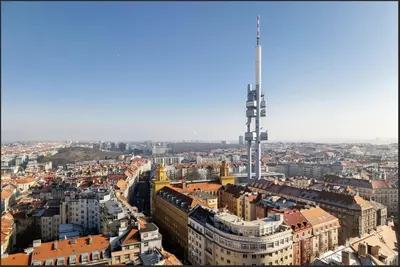 an aerial view of a city with a tall tower at Cosy apt in vibrant area 2 metro stops from Prague's hisorical centre in Prague