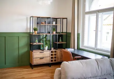 a living room with a desk and a book shelf at Cosy apt in vibrant area 2 metro stops from Prague's hisorical centre in Prague