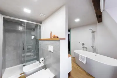 a bathroom with a sink and a glass shower at Nobles Apartments in Prague