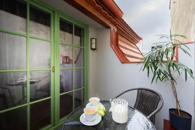 a view of roofs from a window of a building at Nobles Apartments in Prague