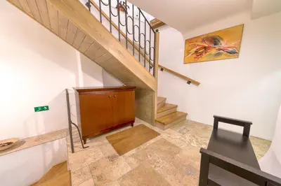 a staircase in a house with a wooden cabinet at Nobles Apartments in Prague