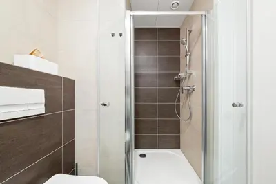 a bathroom with a shower and a toilet at My Mozart apartments in Prague