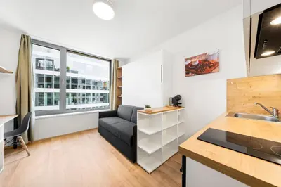 a kitchen and living room with a couch and a sink at My Mozart apartments in Prague