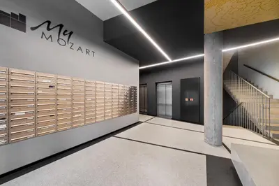 a lobby with a mclaren sign on the wall at My Mozart apartments in Prague