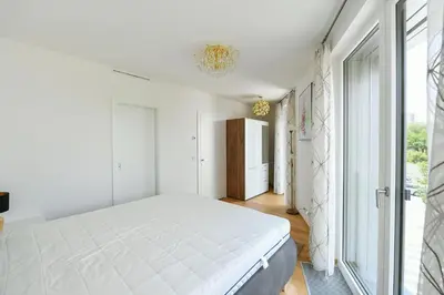 a bedroom with a bed and a desk and a window at Appartment Oliva in Prague