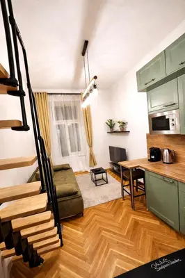 a kitchen and a living room with a table at Nekázanka Boutique Apartment - Near Wenceslas Square in Prague