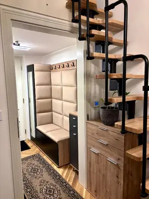 a living room with a staircase leading up to a loft at Nekázanka Boutique Apartment - Near Wenceslas Square in Prague