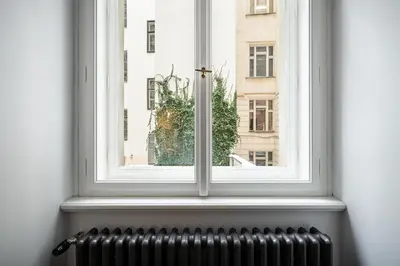 a window with a view of a city at Apartmán 1min River Dancing House in Prague