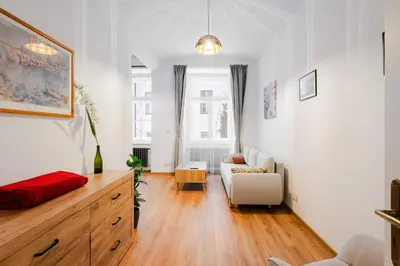 a living room with a couch and a table at Apartmán 1min River Dancing House in Prague