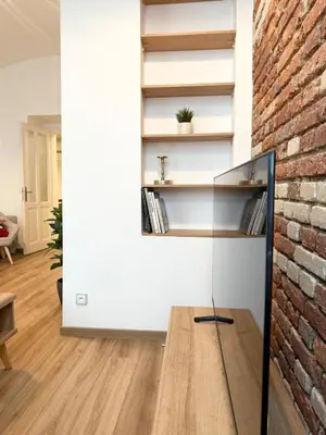 a living room with a brick wall at Apartmán 1min River Dancing House in Prague