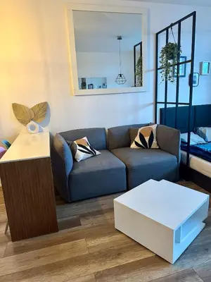 a living room with a couch and a table at Terrace apartment near centre, parking, river park in Prague