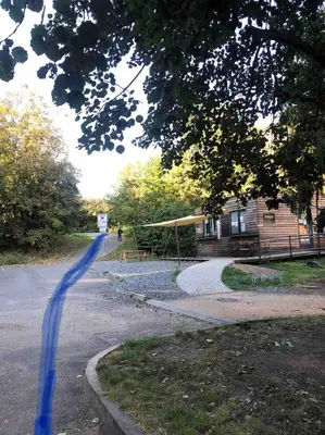 a road leading to a house with a blue line at Terrace apartment near centre, parking, river park in Prague