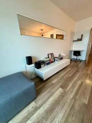 a living room with a bed and a table at Terrace apartment near centre, parking, river park in Prague