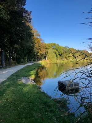 a boat sitting on the side of a river at Terrace apartment near centre, parking, river park in Prague