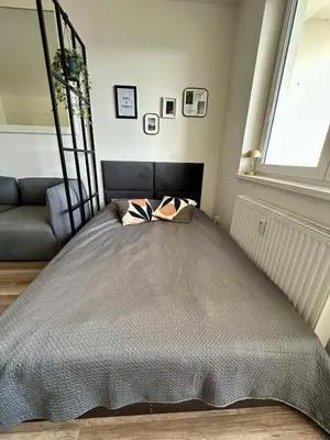 a bed with two pillows on it in a room at Terrace apartment near centre, parking, river park in Prague