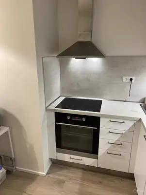 a kitchen with a stove and a microwave at Modern apartment in the Amadeus residence in Prague