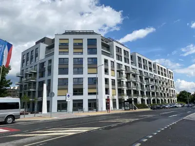 a large white building on the side of a street at Modern apartment in the Amadeus residence in Prague
