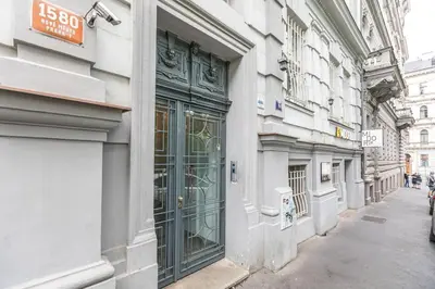 a building with green doors on the side of a street at Entire unit next to Wenceslas Square in Prague