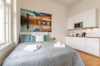 a bedroom with a bed with towels on it at Entire unit next to Wenceslas Square in Prague