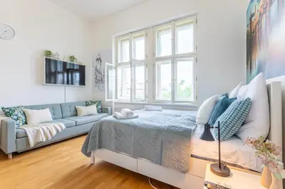 a living room with a bed and a couch at Entire unit next to Wenceslas Square in Prague