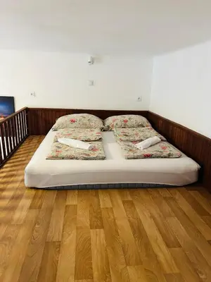a bed in a bedroom with a wooden floor at Apartment v centrum Praha in Prague