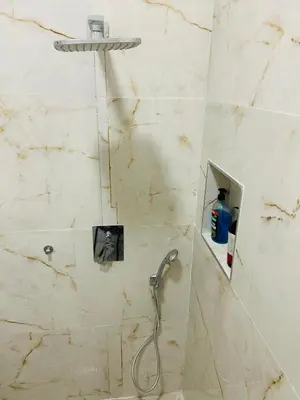 a shower with a shower head in a bathroom at Apartment v centrum Praha in Prague