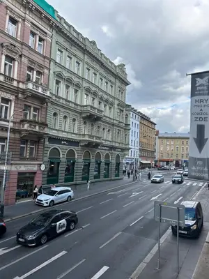 a city street with cars parked in front of buildings at Apartment v centrum Praha in Prague