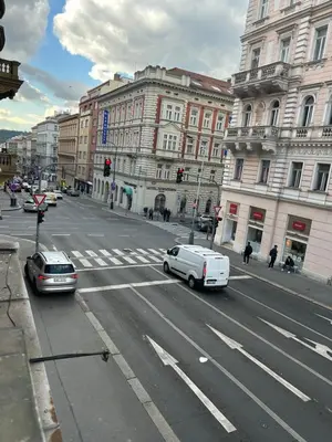 a white van driving down a city street with buildings at Apartment v centrum Praha in Prague