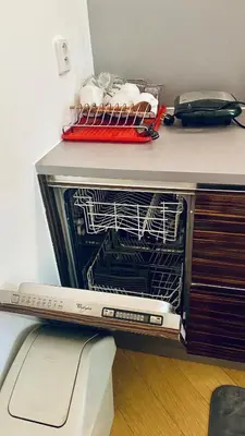an open dishwasher sitting on top of a counter at Luxus room in Prague 2 Square in Prague