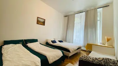 a bedroom with two beds and a window at Luxus room in Prague 2 Square in Prague