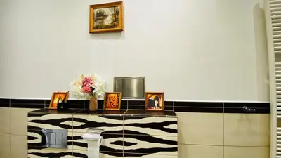 a room with a counter with pictures and flowers on it at Luxus room in Prague 2 Square in Prague