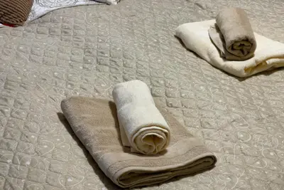 two towels are laying on a bed at Apartment Mozart in Prague