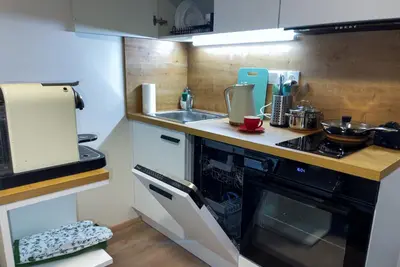 a small kitchen with a stove and a sink at Apartment Mozart in Prague
