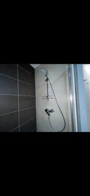 a shower in the corner of a bathroom at Apartment Mozart in Prague