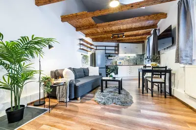 a living room with a couch and a table at Apartmán U Hluboké studny in Rakovník