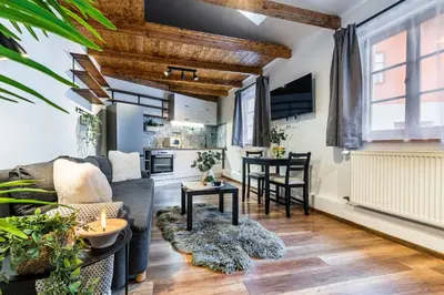a living room with a couch and a table at Apartmán U Hluboké studny in Rakovník