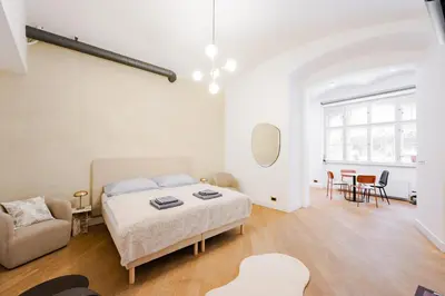 a bedroom with a bed and a couch and a table at LUXURY Apartman 2 min CHARLES BRIDGE in Prague