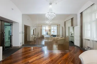 a living room with wood floors and a chandelier at LUXURY Apartman 2 min CHARLES BRIDGE in Prague
