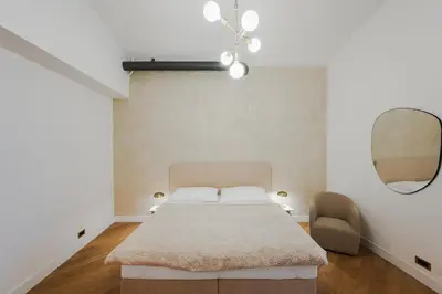 a bedroom with a bed and a mirror and a chair at LUXURY Apartman 2 min CHARLES BRIDGE in Prague